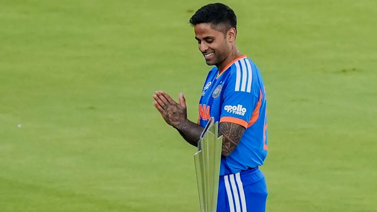 India vs New Zealand Cricketer holding trophy, celebrating victory.