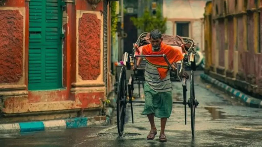 weather 18 March Rickshaw puller walking in rain